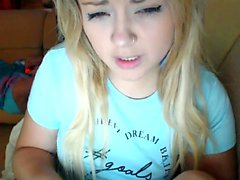 Teen blonde solo fingering on the bed