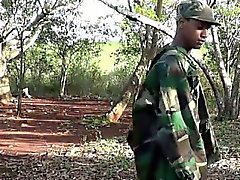 Army boy strokes his wood in the woods