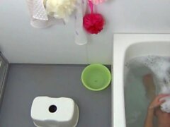Bathing japanese cutie rubs her hairy pussy