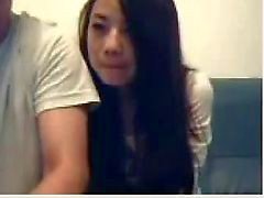 Ensucie los pares Chino alrededor en la webcam