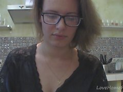 Solo girl with glasses chatting in the kitchen